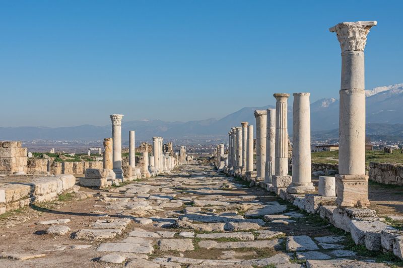 Ancient Roman street with stone columns in Laodicea Turkey under clear blue sky