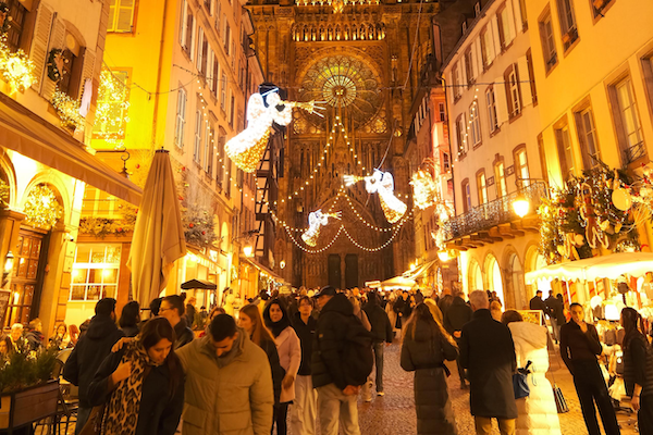 A city street full of people at Christmastime