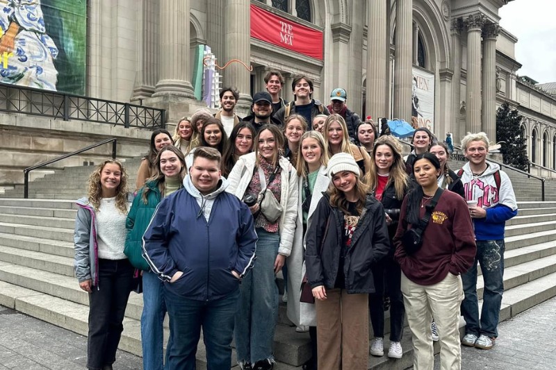 Group of students posing on the steps of The Metropolitan Museum of Art in New York City