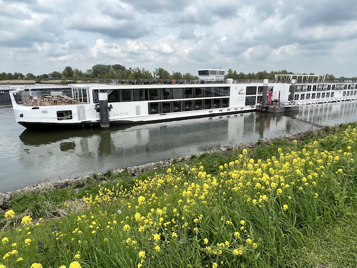 A boat docked at a station in a river